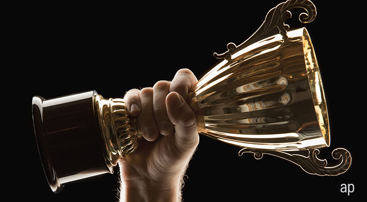 gold trophy on black background